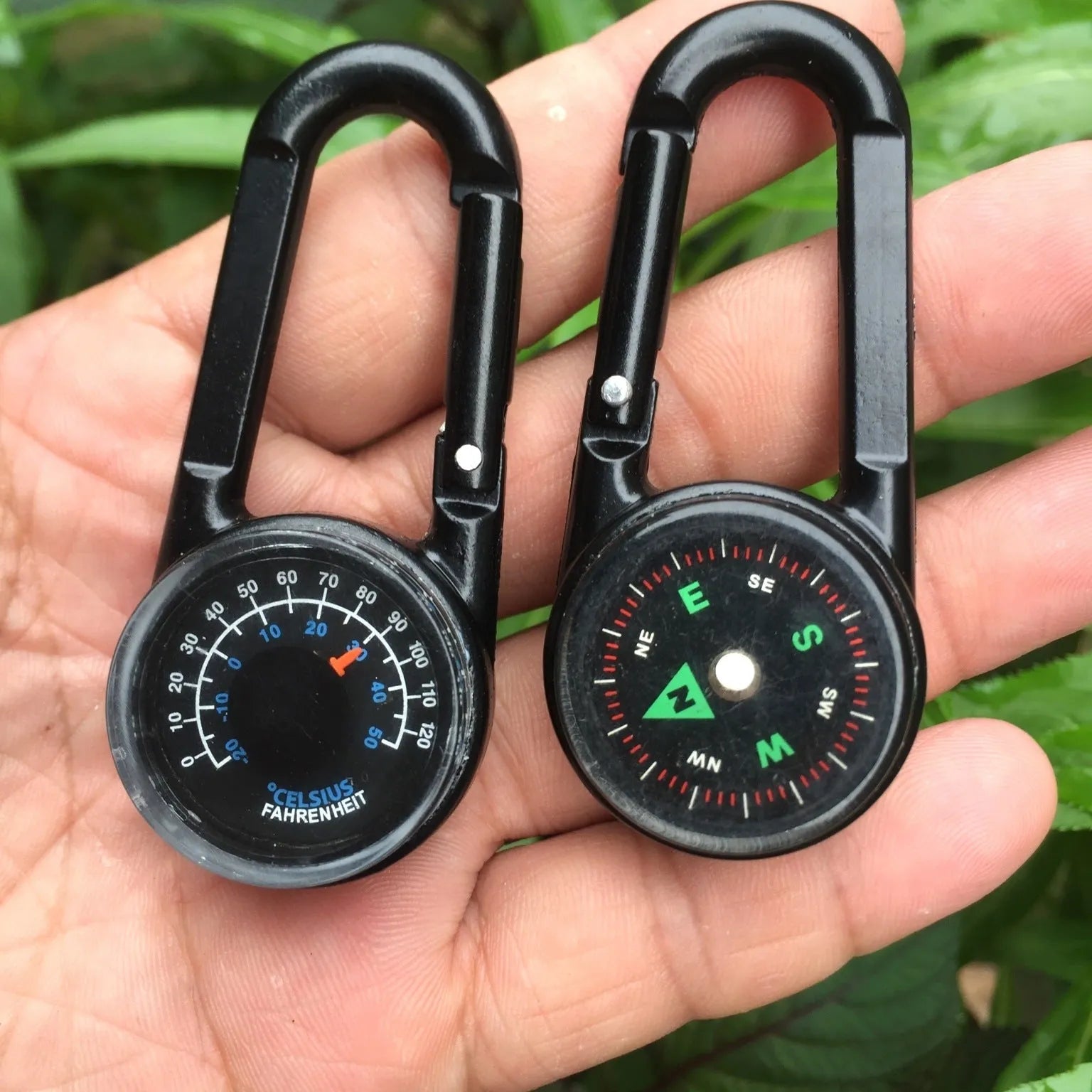 Black zinc alloy double-sided carabiner with a climbing button closure, showing integrated compass and thermometer.