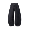 Men's wide leg denim trousers in original cow colour, laid flat to show mid-waist and relaxed fit.