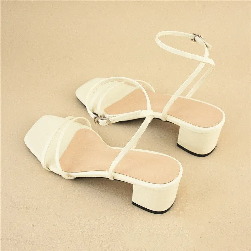Beige women's stiletto sandals with chunky heel, square toe, and ankle buckle.