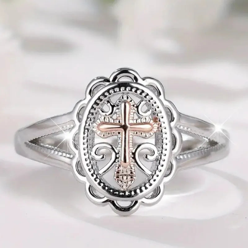 Women's silver cross lace fashion ring with detailed pattern, shown on a finger.