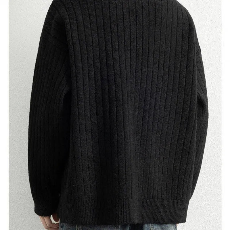Men's grey half-zip loose knit sweater with textured fabric and long sleeves.