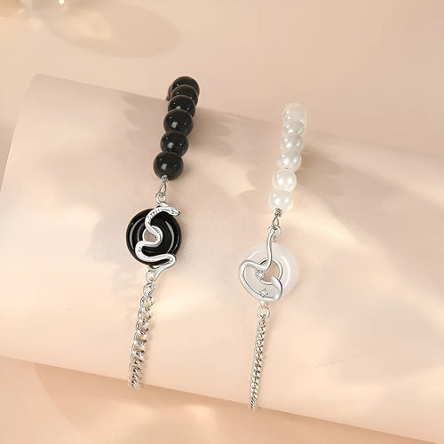 Close-up of a 925 sterling silver bracelet with a snake design, obsidian pearl, and a safe buckle clasp.
