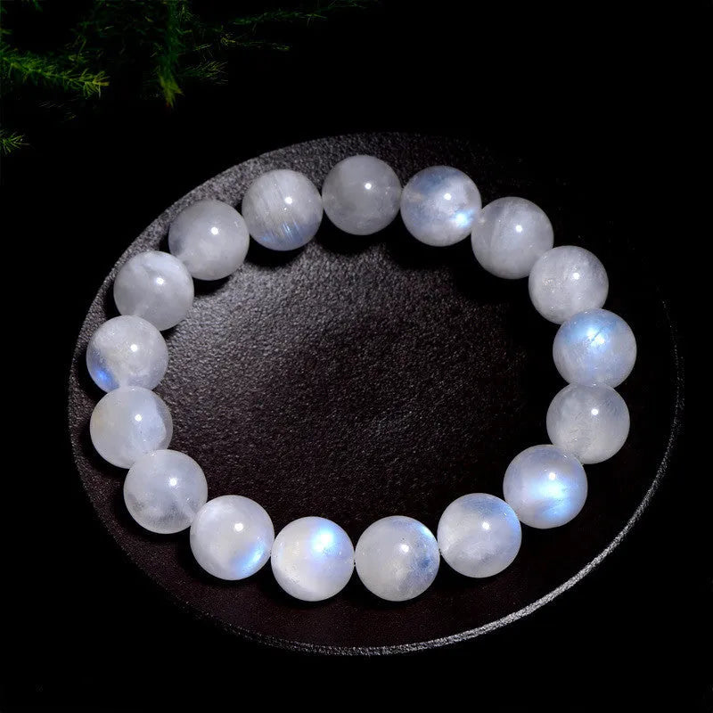 Natural white Blue Moonlight Moonstone round bead bracelet on wrist, showing polished gemstone beads.