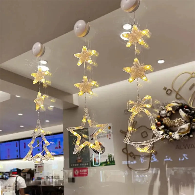 Set of three Christmas LED light pendants with suction cups, showing star, deer, and tree designs on a window.