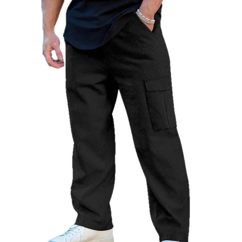 Men's loose-fitting corduroy cargo trousers in a brick red colour with a wide-leg silhouette.