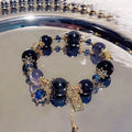 Galaxy-coloured women's bracelet with snowflake pendant, bow, and heart designs