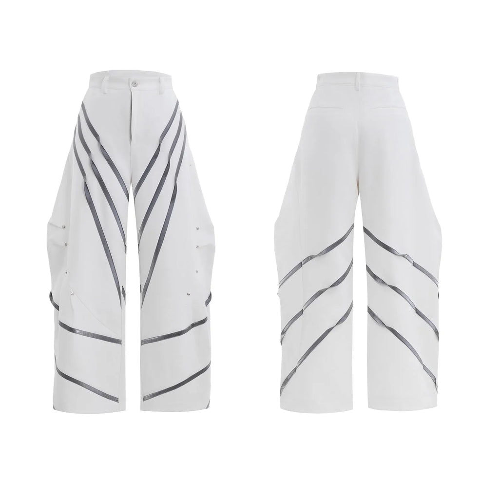 Men's black trousers with metal striped rivet and pleated detail on a three-dimensional cut.