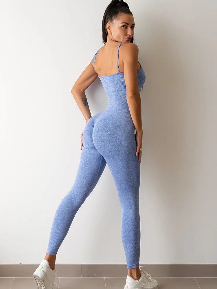A woman wearing a black sleeveless, backless unitard jumpsuit with thin spaghetti straps.