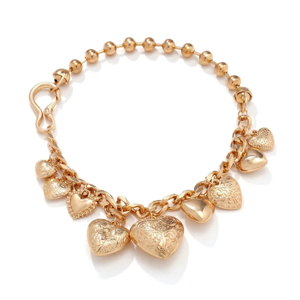 Carved heart-shaped pendant necklace on a metal chain, shown in gold and white K colour options.