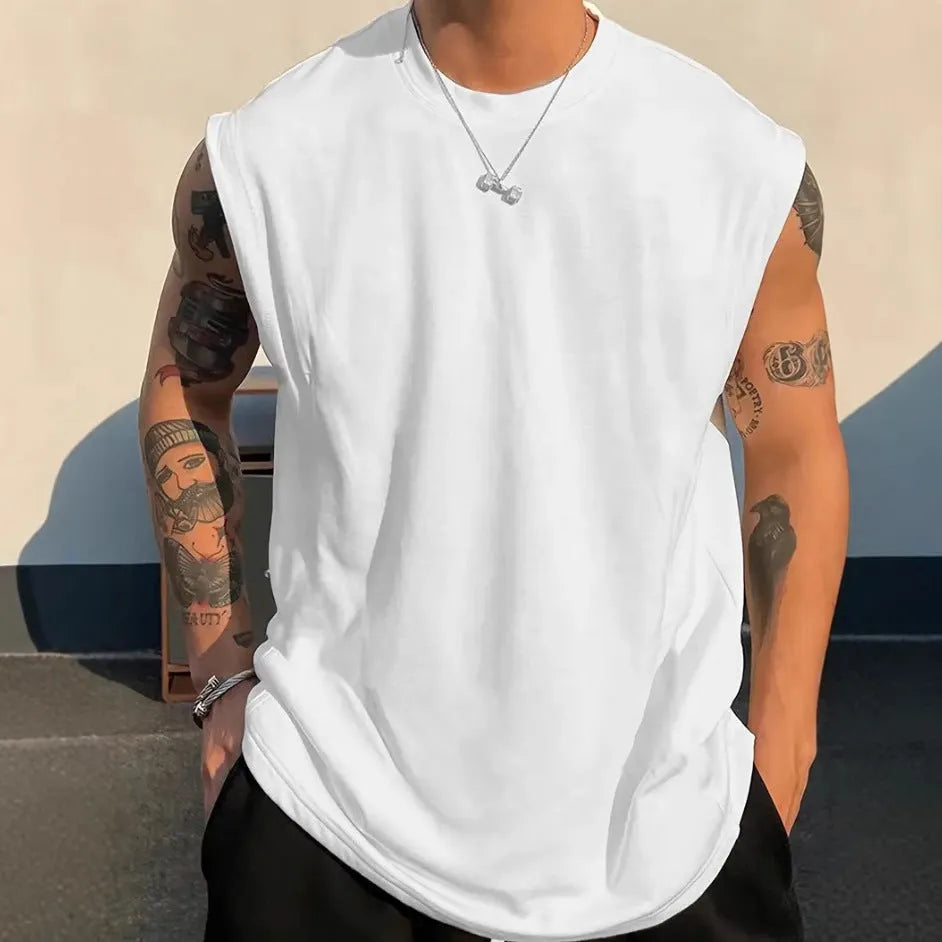 Men's loose sleeveless cotton tank top in a solid colour on a hanger