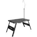 Folding black camping cooking tea table that functions as both barbecue stove and dining surface
