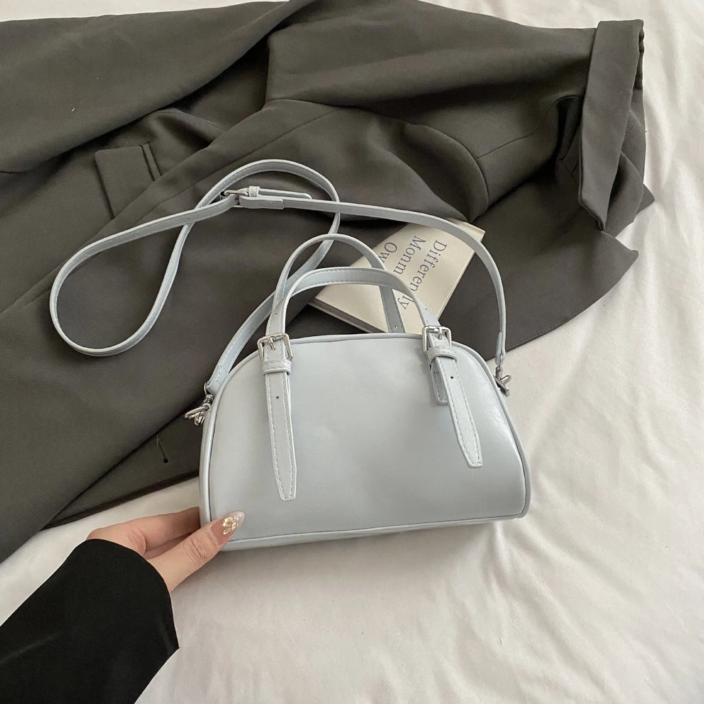 Women's square shoulder bag in PU leather with soft shell shape and optional ribbon pendant
