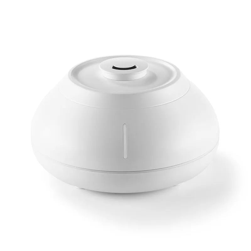 Round white aroma diffuser with colourful LED flame effect on desktop