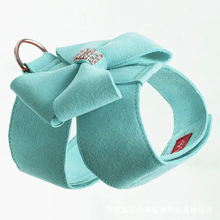 A cute pink microfiber puppy chest strap with a bowknot, showing the adjustable design.