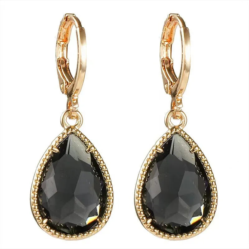 Copper-coloured rare earth metal and glass geometric saturn water drop earrings in multiple colours.
