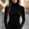 Slim-fit stretch knitted zipper collar top in black, shown on a model, solid polyester fabric, pullover style.
