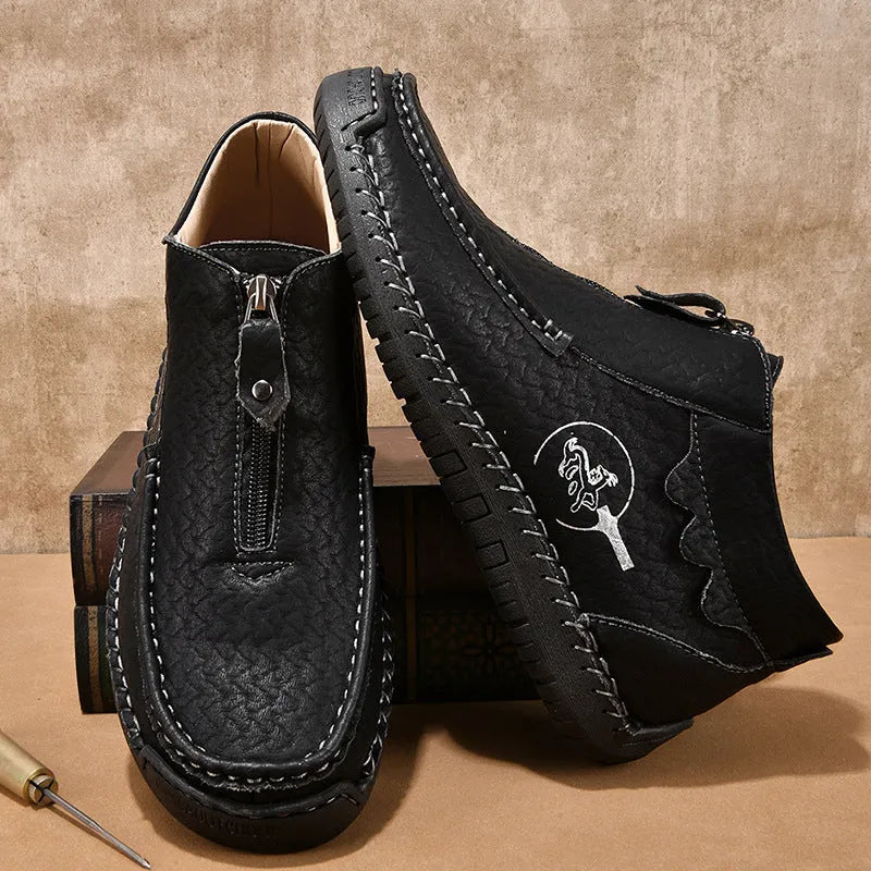 Men's black slip-on loafers with round toe and rubber sole on a plain background.