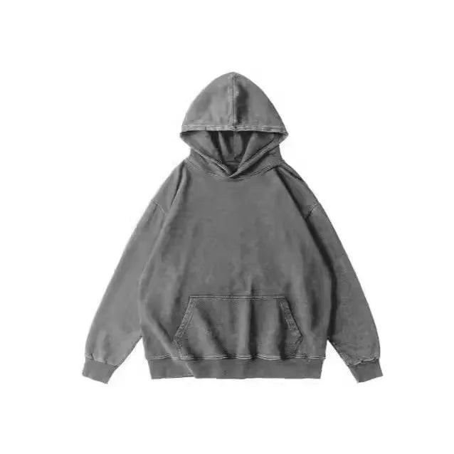 Man wearing a loose brown washed cotton hoodie with a batik pattern and drop shoulders