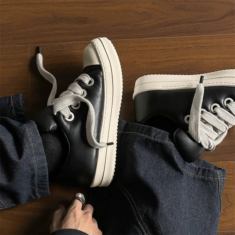 Men's black slip-on casual shoes with raised sole, leather uppers, and rubber soles showing round toe and shallow cut design