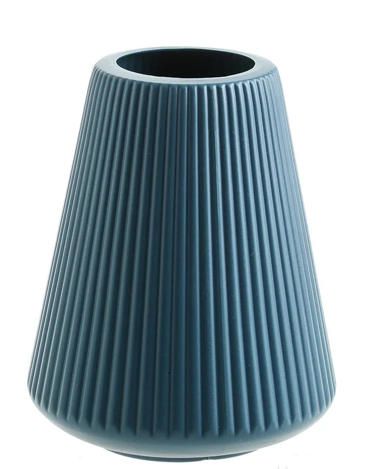Colourful melamine plastic decorative flower vase, 16 cm by 20 cm, on a desktop.