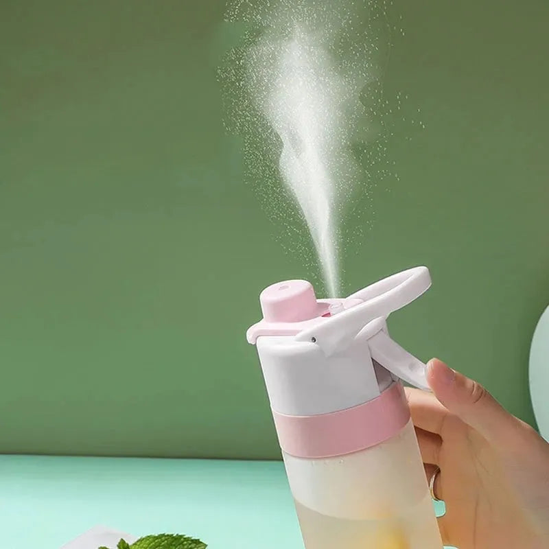 White plastic spray water bottle with handle strap and leakproof lid on a gym bag.