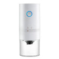 Black and white portable electric coffee grinder with USB-C cable on a kitchen counter