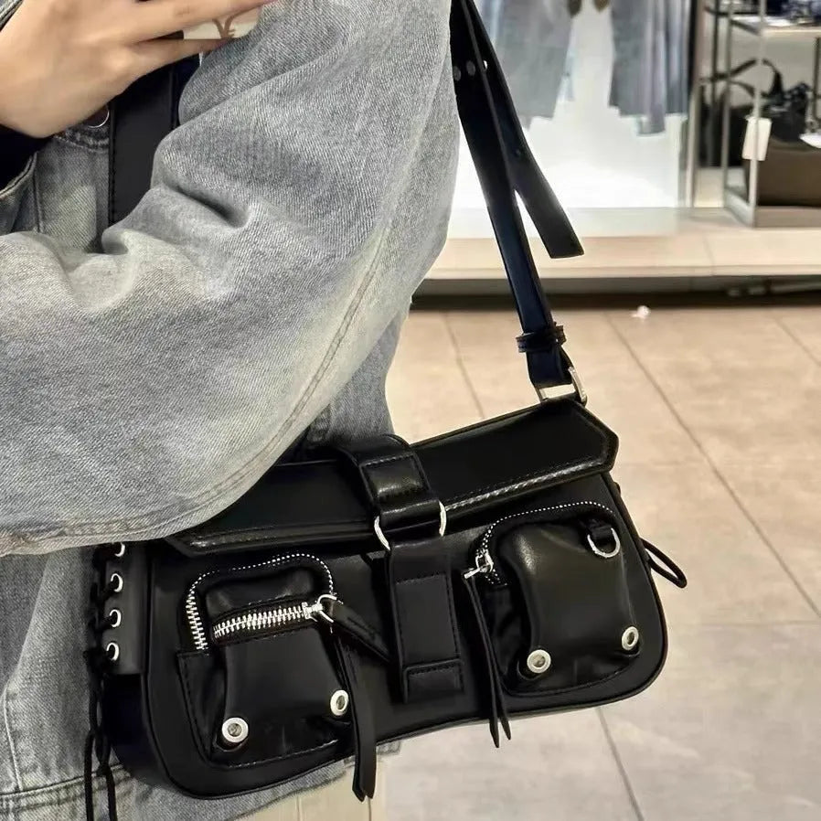 Black medium-hard PU women's baguette messenger bag with adjustable strap and zippered internal change compartment.