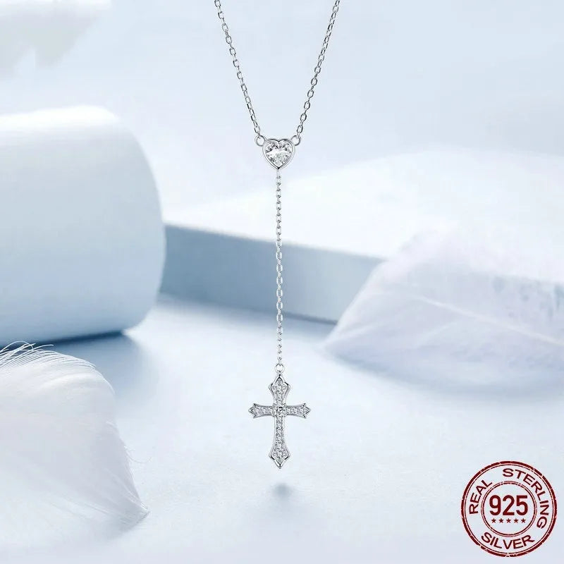 Close-up of a sterling silver V-neck love cross pendant on an O-ring chain.