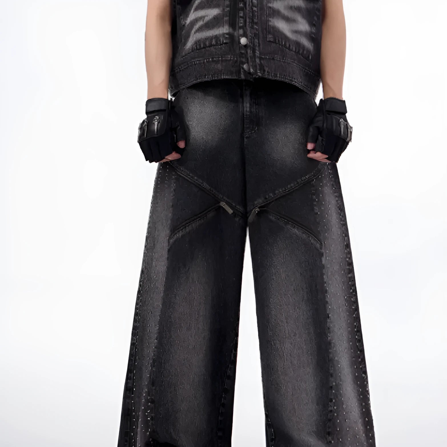 Black and grey washed wide leg cotton denim trousers and matching waistcoat set laid flat.