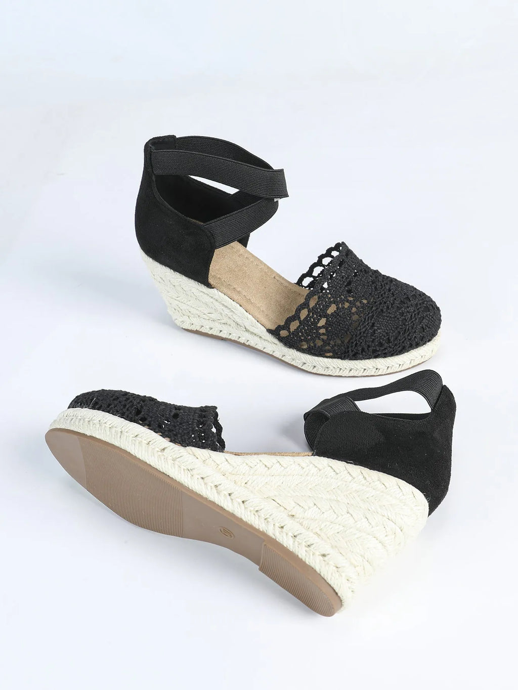 Women's apricot and black canvas wedge sandals with a round toe and high heel.