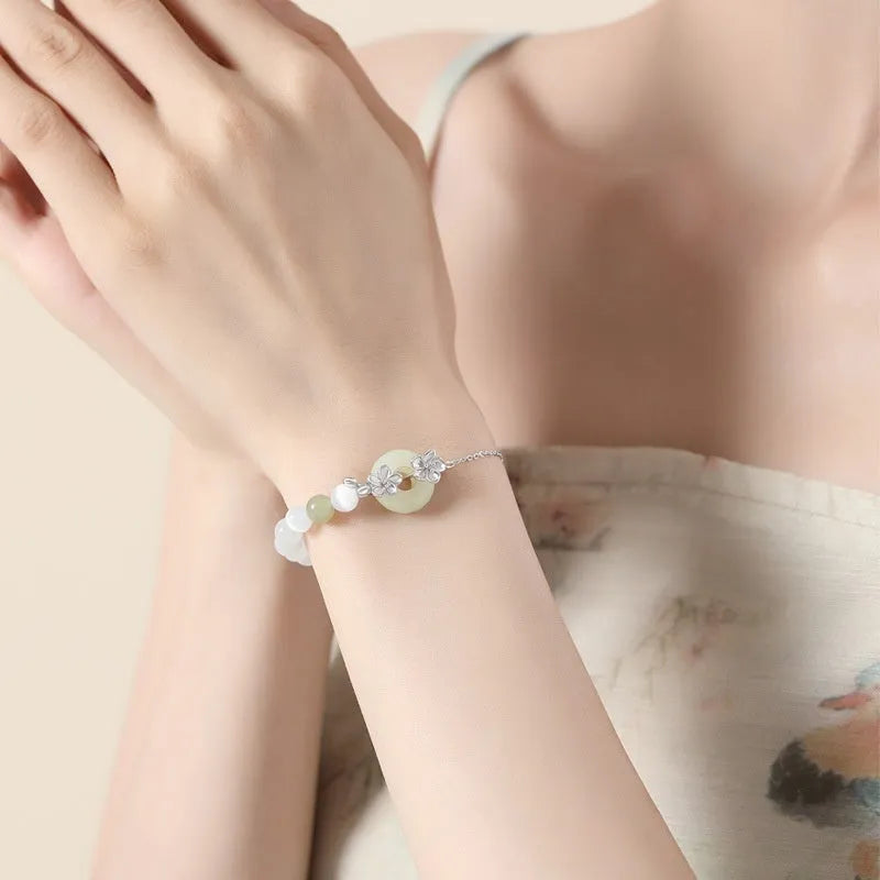 Pure silver peach blossom bracelet for women with a safety buckle clasp in gold or white gold colour.