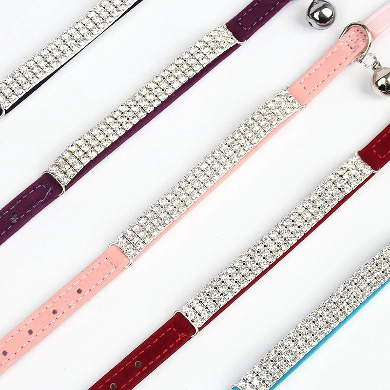 Red velvet cat collar with rhinestones on a white background, showing buckle and adjustable strap.
