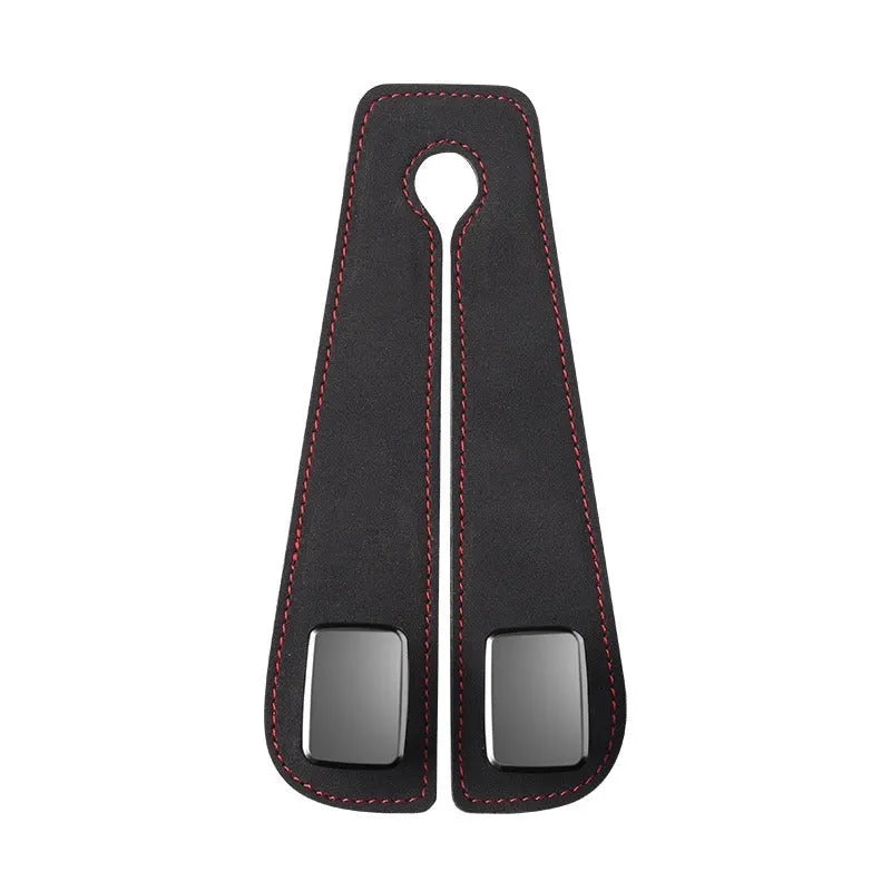 Alloy car seat hook clipped to headrest post in black, showing flip-down design for bag storage.