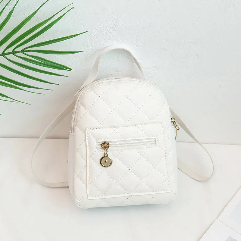 A white hard-shell girls backpack with embroidery, showing its square shape and soft top handle.