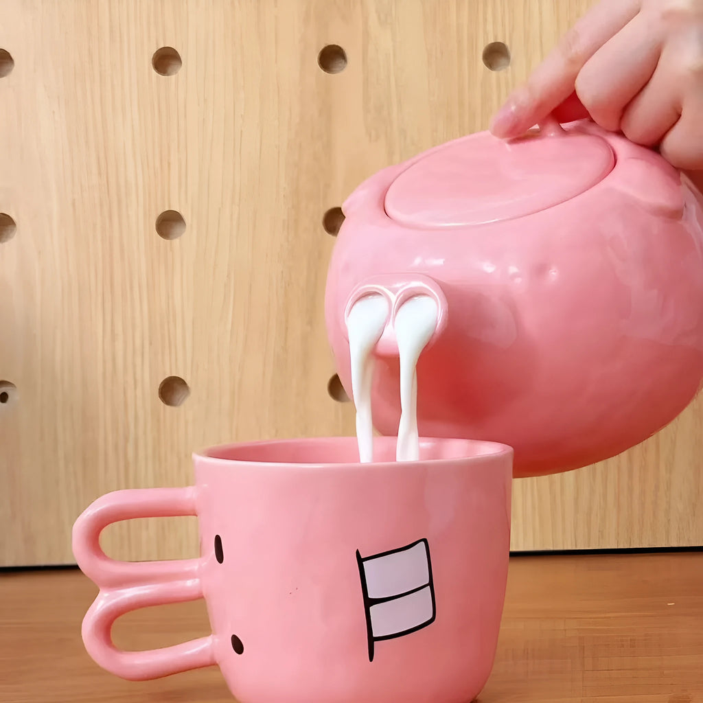 Creative ceramic piggy teapot nose mug set with pink pig pot and rabbit cup on a table