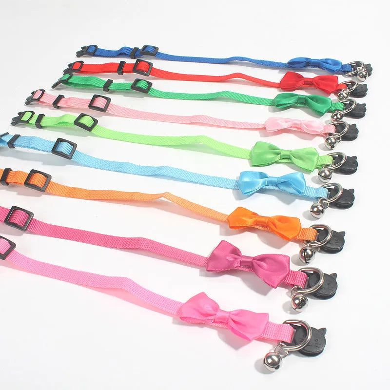 Adjustable striped nylon cat collar with a small silver bell attached, shown in multiple colour options.