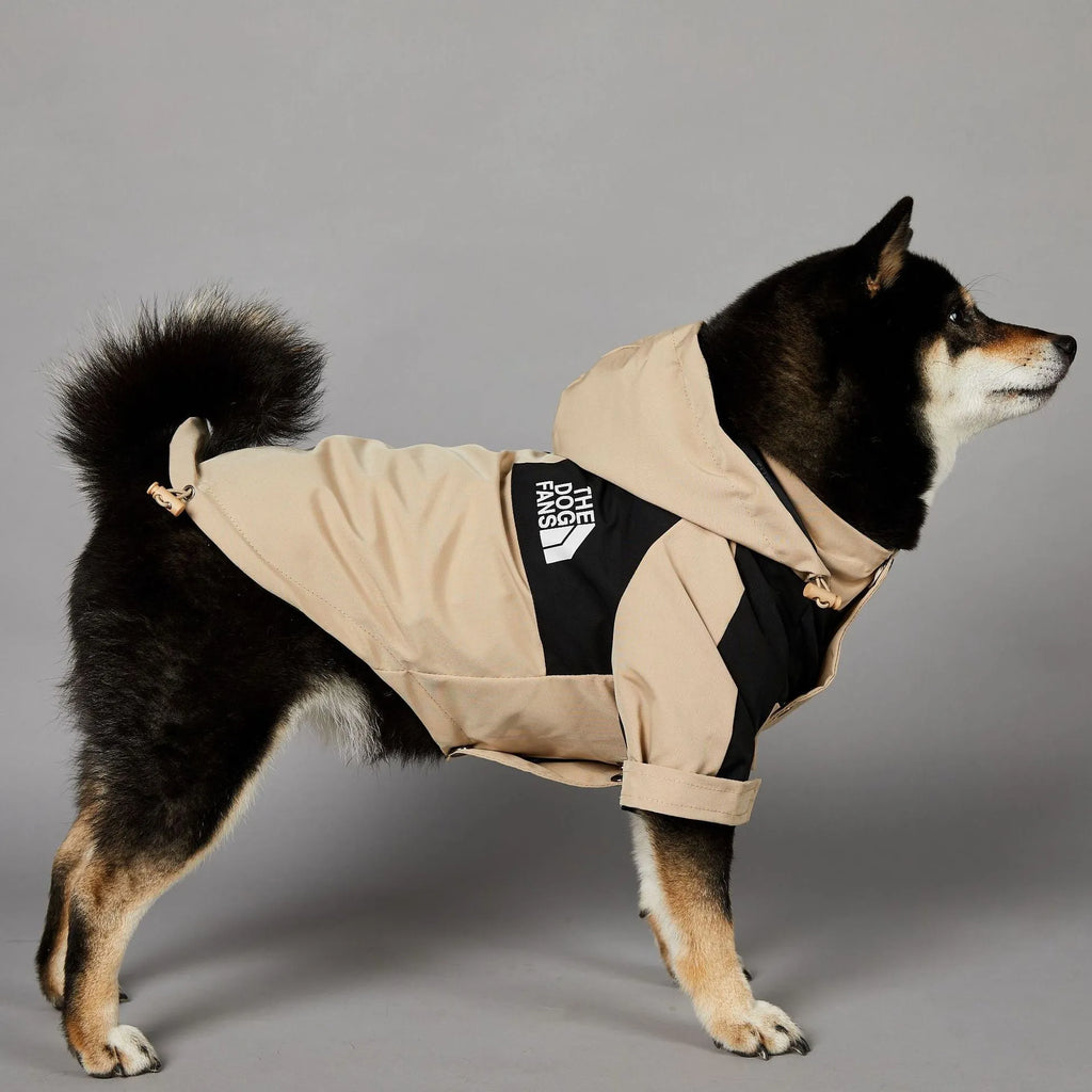 Khaki coloured polyester shell jacket for a dog on a white background.