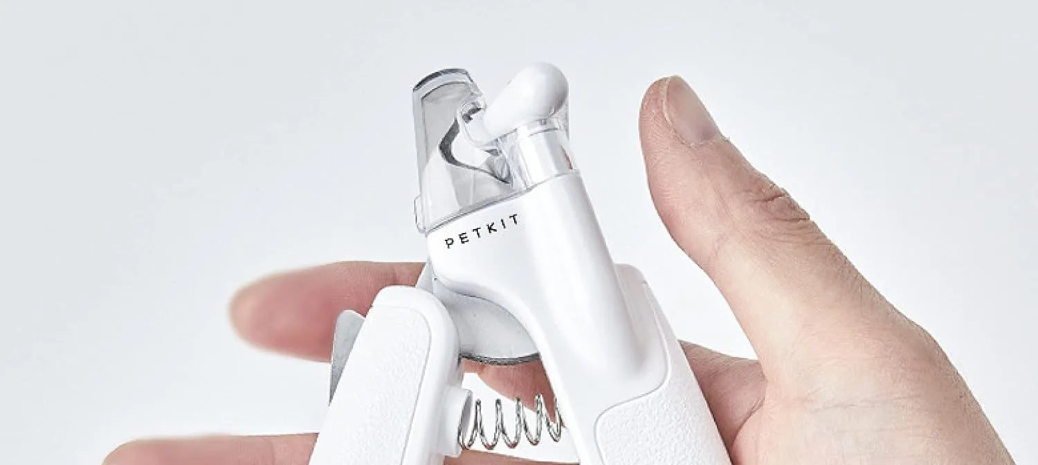 White pet nail clippers with LED light, transparent anti-splash guard, and triangular blade for cats and dogs