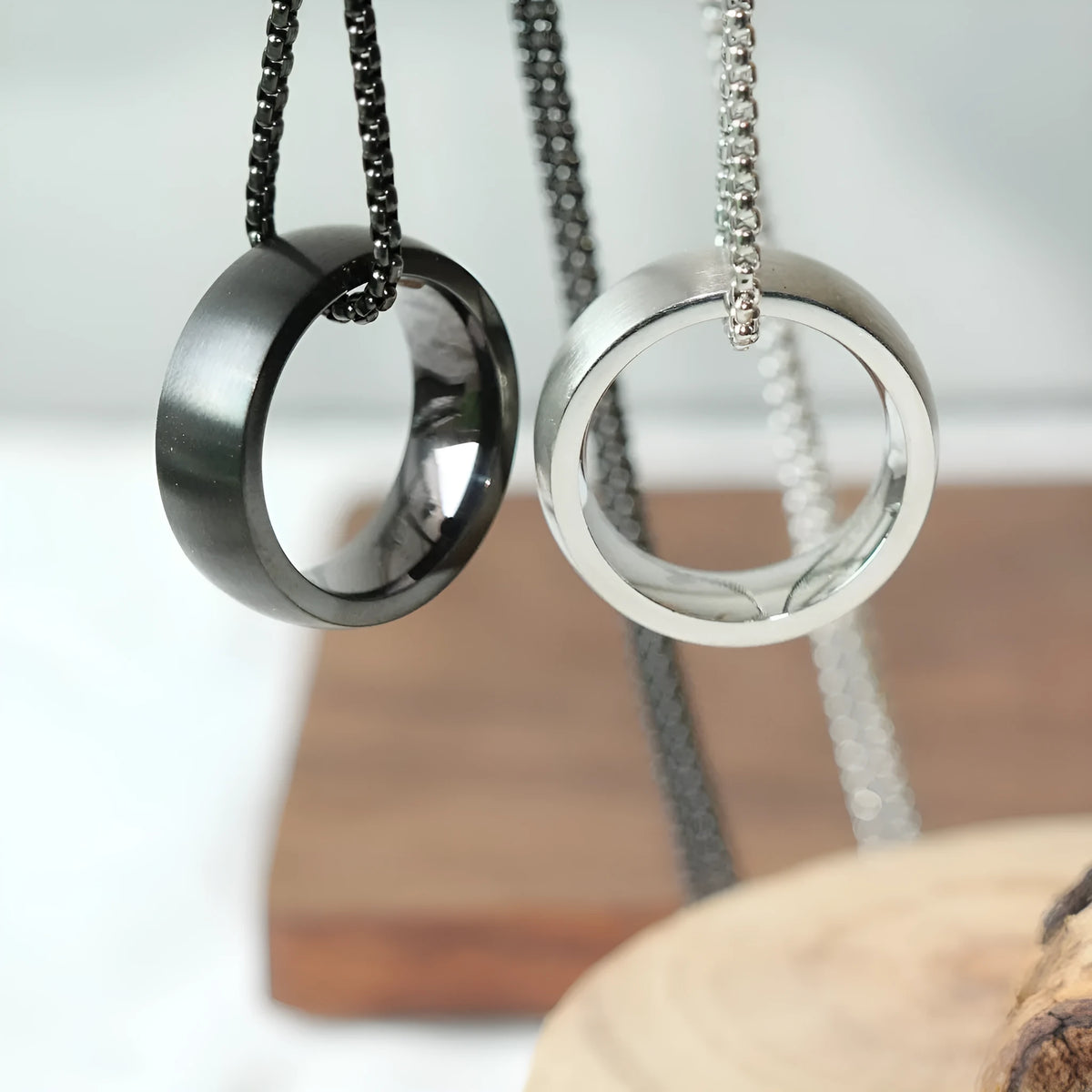 Men's silver stainless steel pearl chain necklace with titanium steel circle pendant on grey background