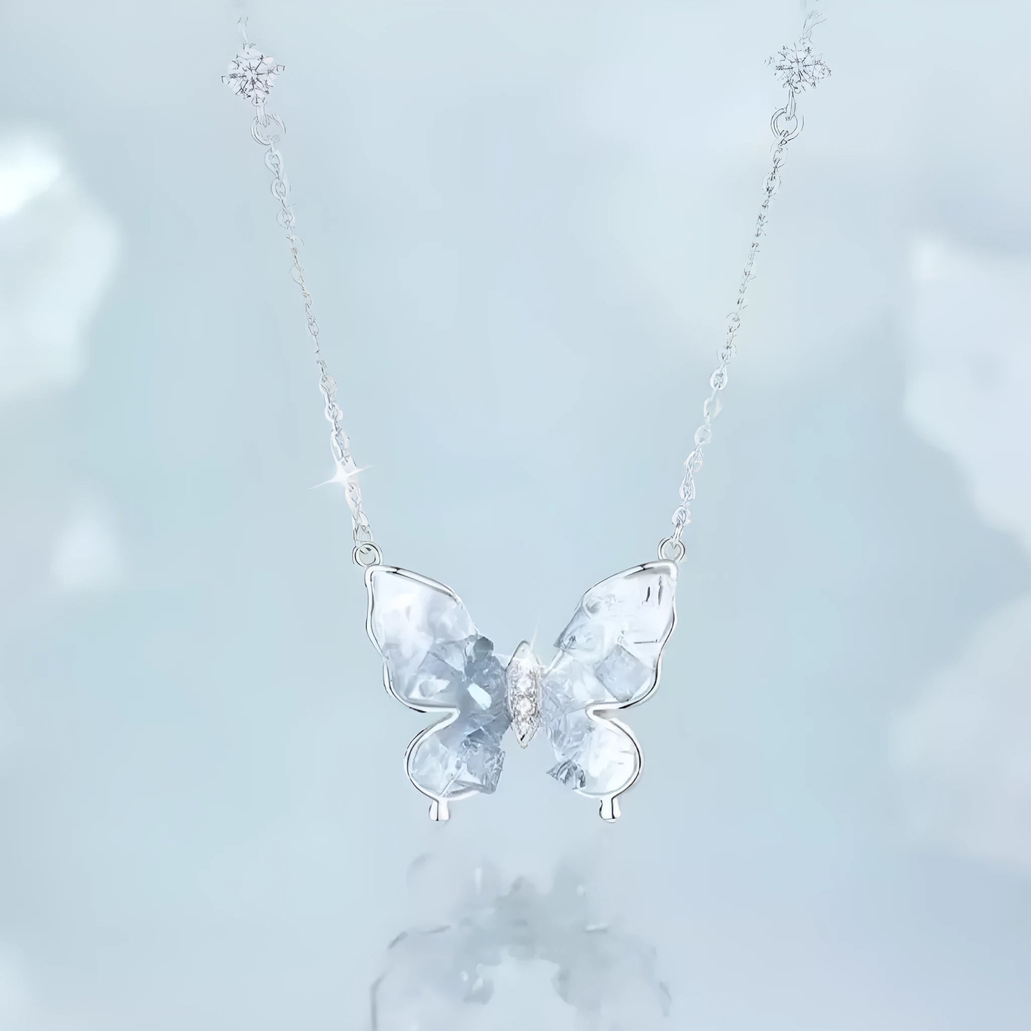 Bingyu adjustable silver butterfly necklace on a dark background, showing the icy electroplated pendant and O-ring chain.