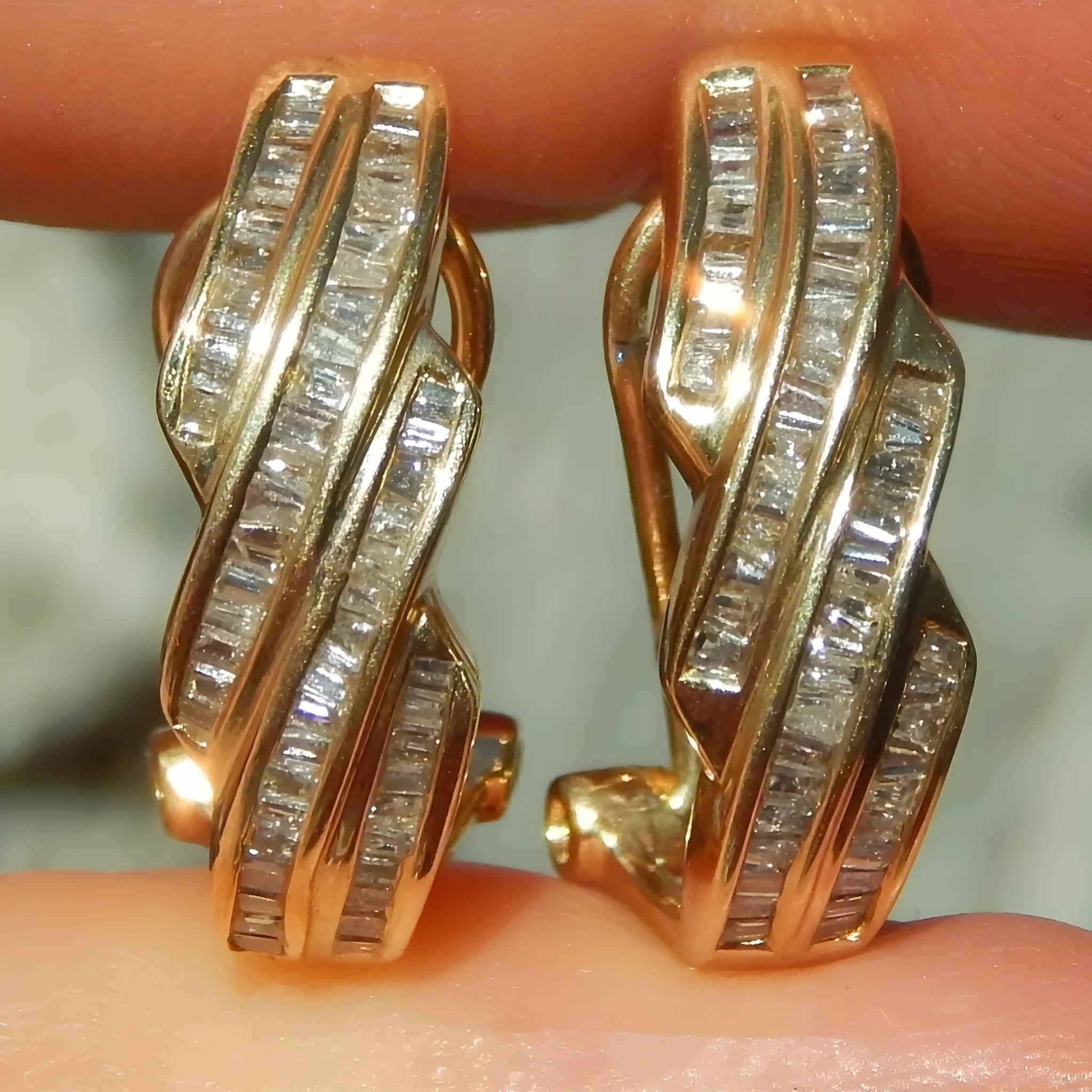 A pair of gold-coloured geometric copper earrings with a round design on a white background.