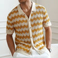 Man wearing a blue short-sleeve sweater with a textured hollow jacquard corrugated pattern and flocked detail.