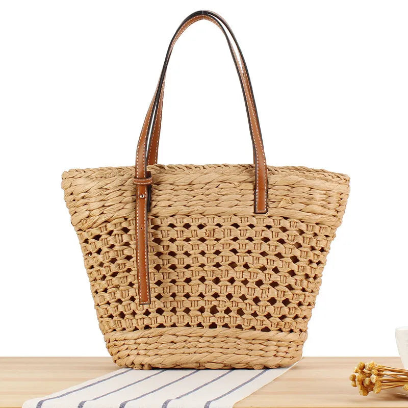 Beige paper string woven large capacity shoulder bag showing horizontal square shape and adjustable strap.
