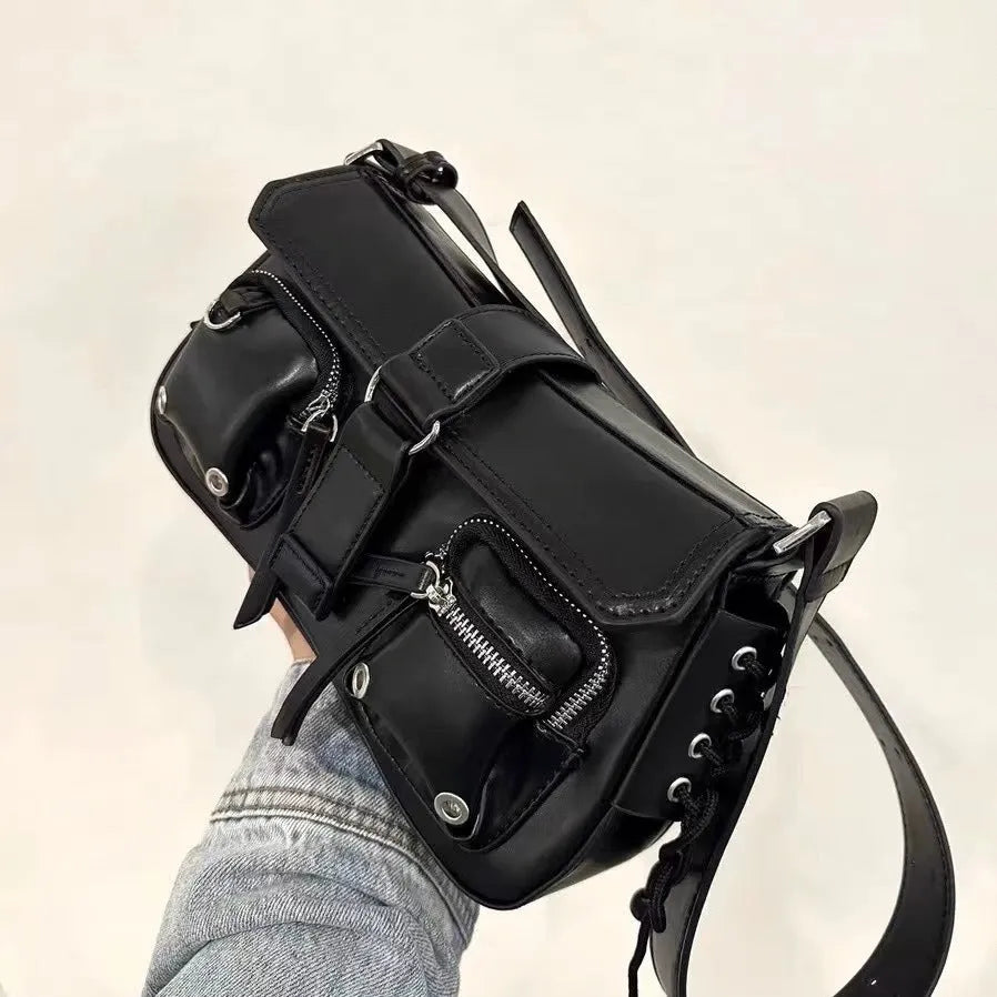 Black medium-hard PU women's baguette messenger bag with adjustable strap and zippered internal change compartment.