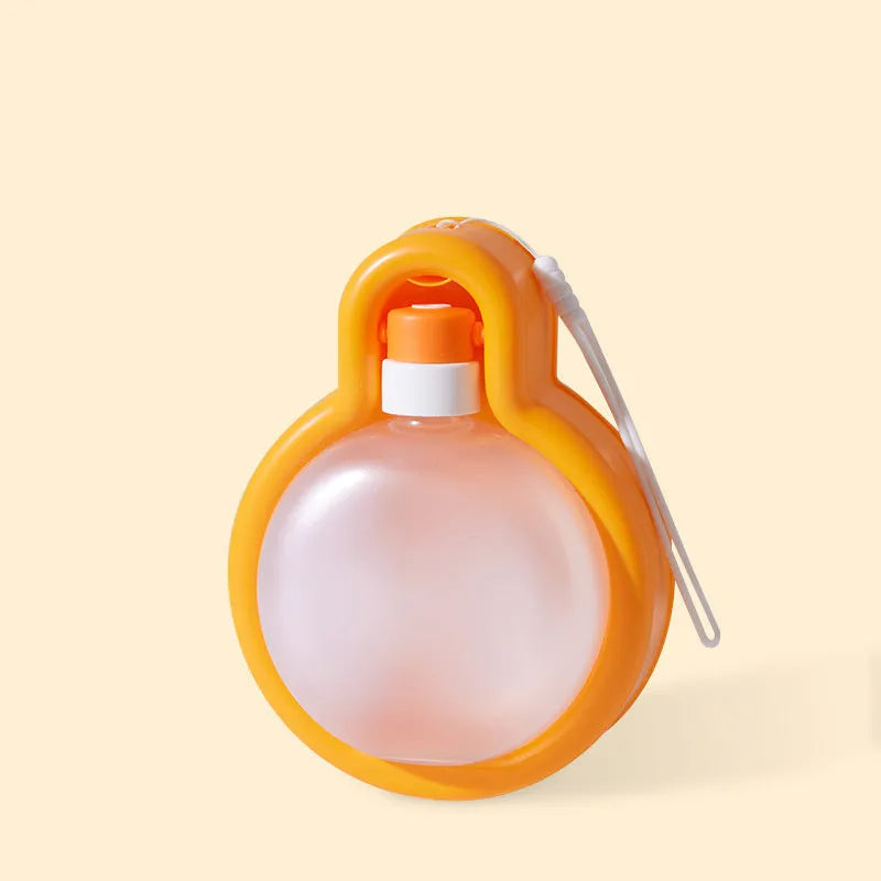 Green portable dog travel water bottle and bowl dispenser on a table.