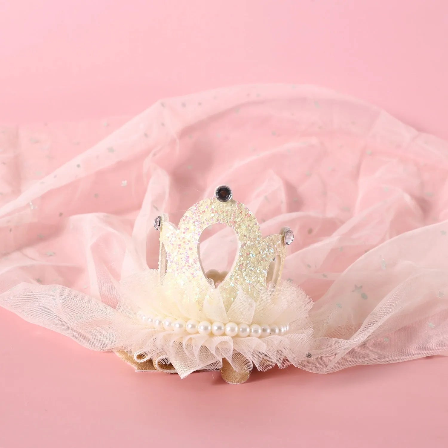 Cat wearing princess crown headdress with veil for wedding or birthday celebration