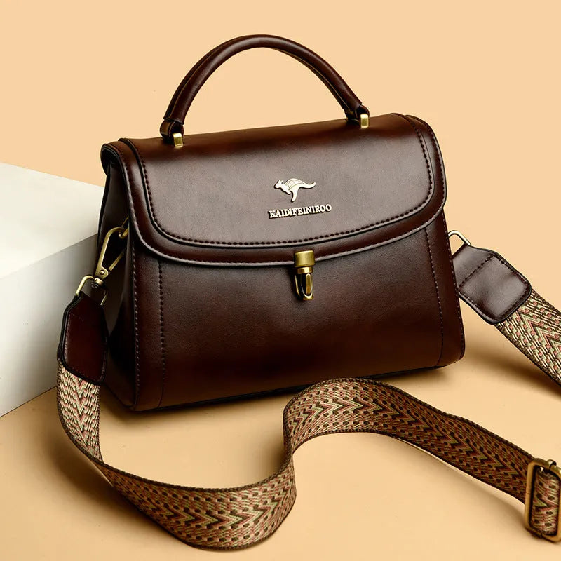 Women's textured PU crossbody handbag in horizontal square shape with rear pocket, black colour