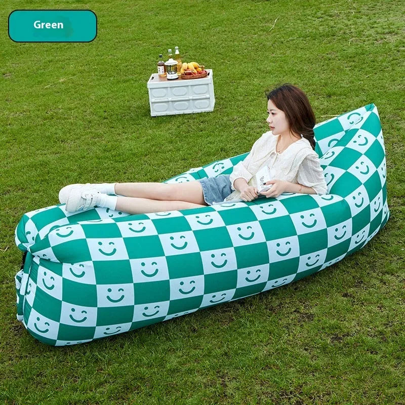 Yellow smiling face tip inflatable portable outdoor sofa seat on grass