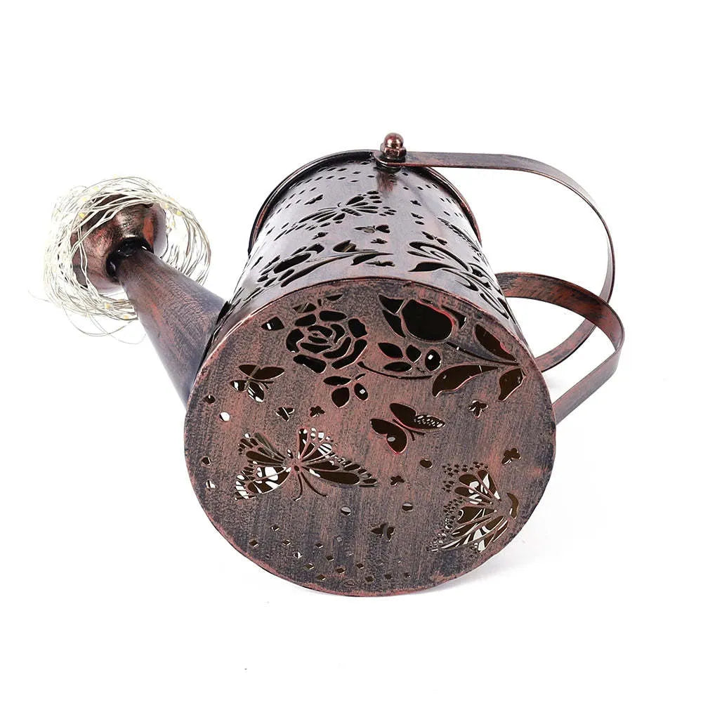 Solar-powered iron garden lamp with a butterfly pattern and warm white LED light.