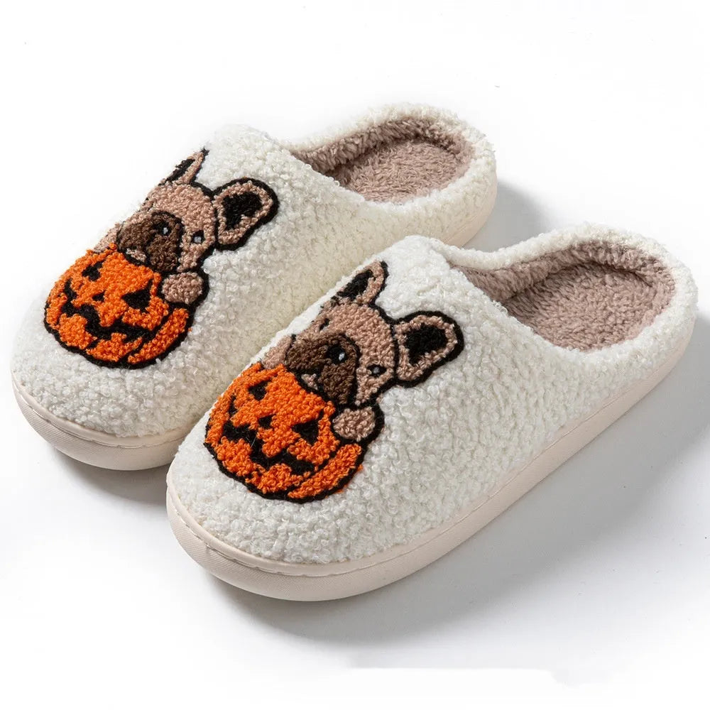 Black and white Halloween plush slippers with pumpkin design, round toe, and textured non-slip TPR soles.